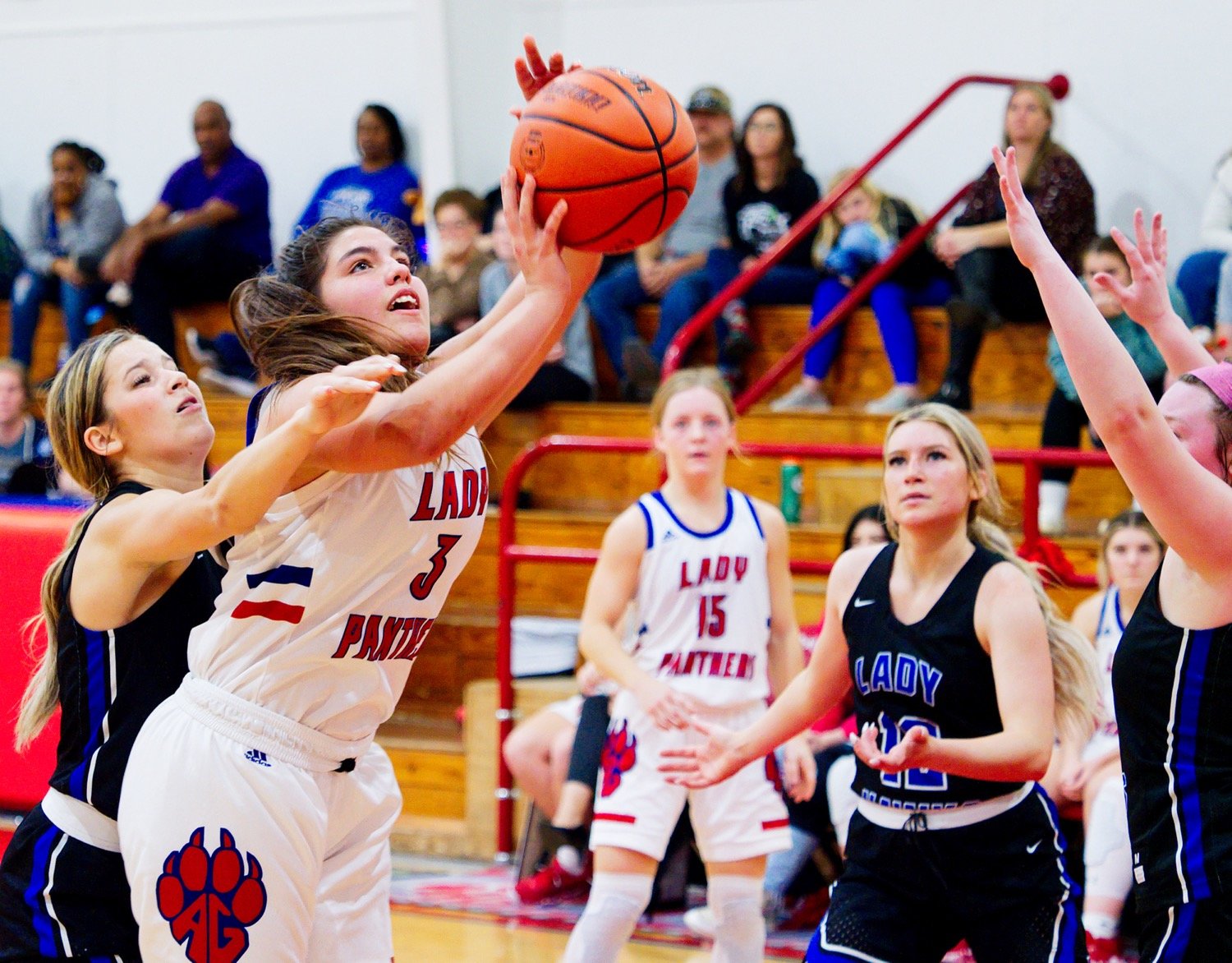 Erin Langston puts up a shot in the lane while being fouled. [see more shots, buy basketball photos]